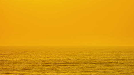 Golden-Sunset-Sky-Over-Foggy-Seascape-With-Huge-Sun-Setting-Down