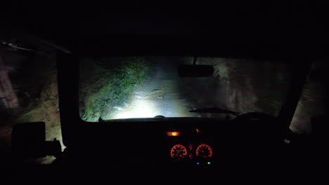 POV-Jeep-driving-up-a-bumpy-track-at-night-time