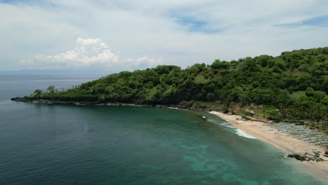 Empty-white-sand-beach-in-East-Bali-at-Pantai-Prasi-on-sunny-day-with-turquoise-ocean,-aerial