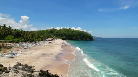 Aerial-of-pristine-white-sand-beach-in-East-Bali-on-sunny-day-at-Pantai-Prasi