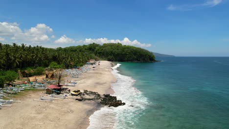 Aerial-of-Pantai-Prasi-white-sand-beach-in-Bali-Indonesia-on-sunny-day-with-turquoise-ocean