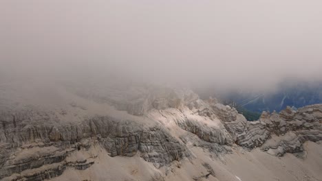 Aerial-forward-view-of-Monte-Pelmo-in-its-peak-in-mist-and-clouds