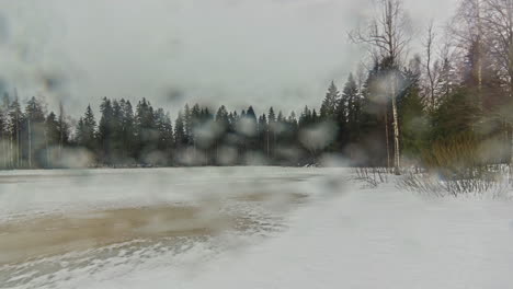 Static-shot-of-snow-covering-ground-on-a-rainy-day-rural-countryside-in-timelapse