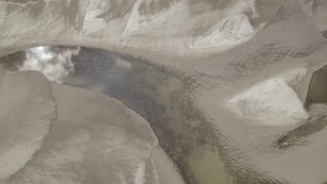 Aerial-top-down-shot-of-the-drying-riverbed-with-just-few-small-ponds-remaining