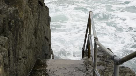 Tidal-Waves-Hit-On-The-Concrete-Staircase-At-Newquay-Harbour-In-Cornwall,-United-Kingdom