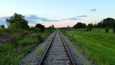POV-traveling-in-shot-of-train-track-over-charming-scenery