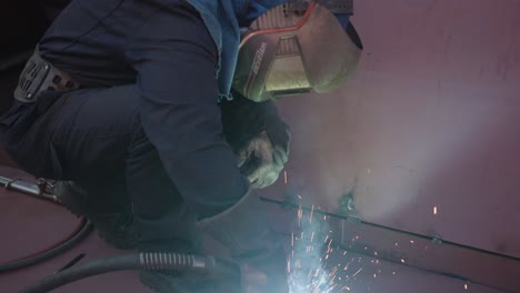 Masked-man-repairing-a-ship-with-welding-machine