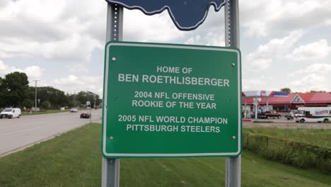 Findlay,-Ohio-sign-showing-hometown-of-Ben-Roethlisberger-with-gimbal-video-moving-forward