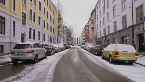 Snowy-city-street-in-Oslo-2,-Majorstuen-neighborhood-with-cars,-snow,-winter