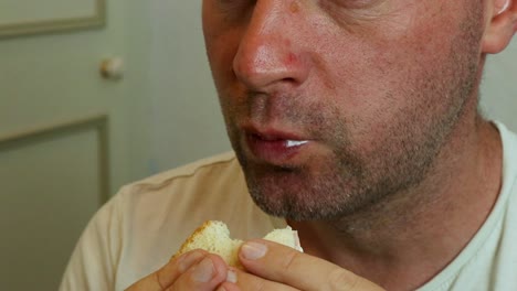 A-man-eating-a-sandwich-close-up