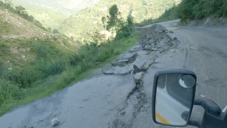 Eine-Point-of-view-aufnahme-Eines-Fahrzeugs,-Das-Durch-Eine-Beschädigte-Straße-Durch-Kürzliche-Erdrutsche-In-Den-Ausläufern-Des-Indischen-Himalaya-In-Himachal-Pradesh-Fährt