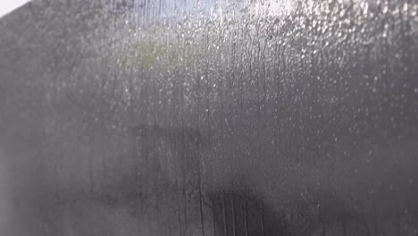 Spraying-a-Coating-of-Wet-Liquid-on-the-Body-of-a-Car,-Close-up