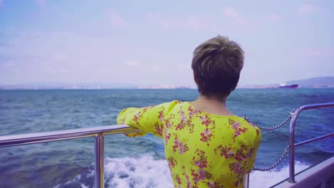 Slow-motion-shot-of-woman-looking-at-the-view-from-the-boat