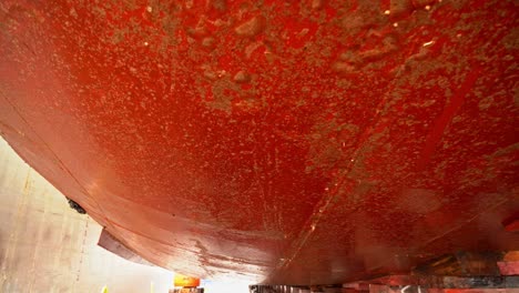Dirty-ships-hull-below-ships-bottom-seen-from-inside-drydock---Dirt-affecting-fuel-consumption-and-efficiency---Docking-for-cleaning