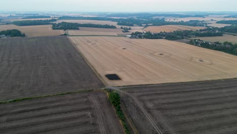 Drone-flyover-of-fields-with-vehicle-tracks-and-a-scorch-mark