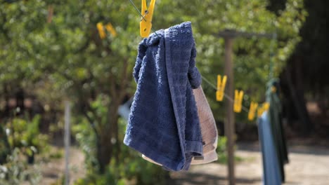 Kitchen-Blue-And-White-Fabrics-Hanging-On-Outside-Clothesline-On-A-Sunny-Day