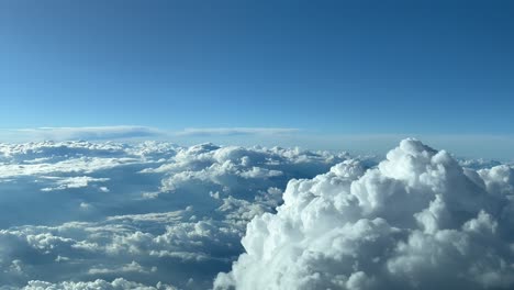 Unique-pilot-point-of-view-during-cruise-overflying-the-top-of-a-cumulonimbus-cloud-at-12000-metres-high