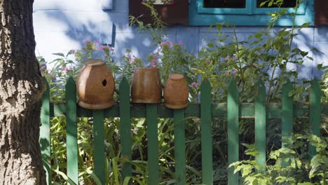 Clay-pots-on-the-wooden-fence