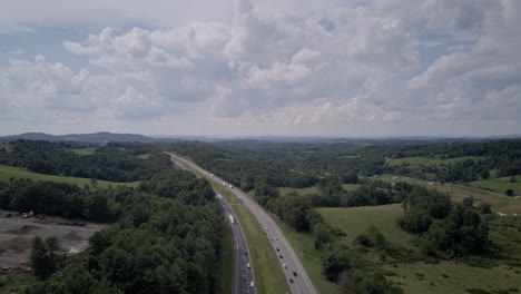 Aerial-crane-hyperlapse-shot-revealing-fast-traffic-on-Interstate-40-in-North-Carolina-with-afternoon-clouds