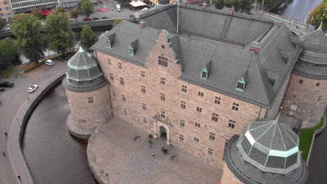 Wide-angle-shot-from-a-drone-flying-towards-Örebro-castle-in-Sweden