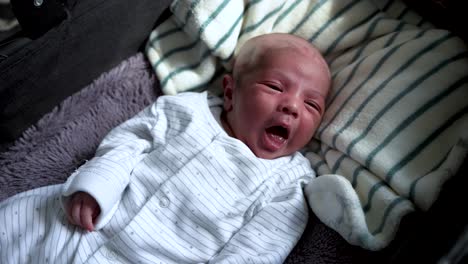Overhead-View-Of-Muslim-11-Day-Old-Newborn-Baby-Boy-With-Shaved-Head-Yawning