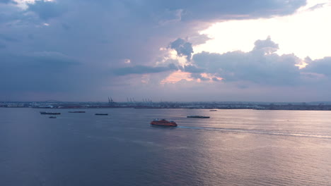 Slow-aerial-pan-shows-two-Staten-Island-Ferries-approaching-each-other-in-the-New-York-Harbor-during-a-dramatic-sunset