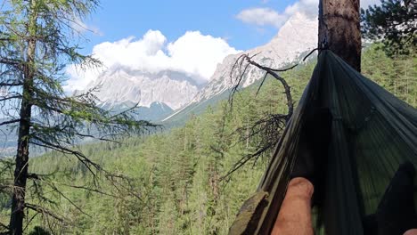 Person-relax-in-Hammock-with-view-over-Biggest-Mountain-in-Germany-called-Zugspitze