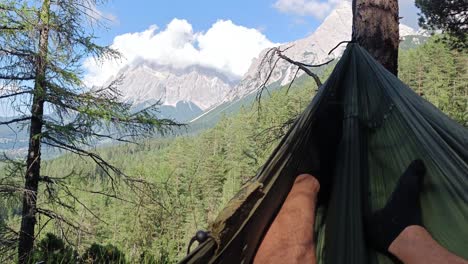 Person-lay-in-Hammock-with-view-over-Beautiful-Mountain-Area
