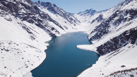 Andes-Mountain-Range-With-Lake-Del-Inca-In-Portillo,-Chile-In-Winter---aerial-drone-shot