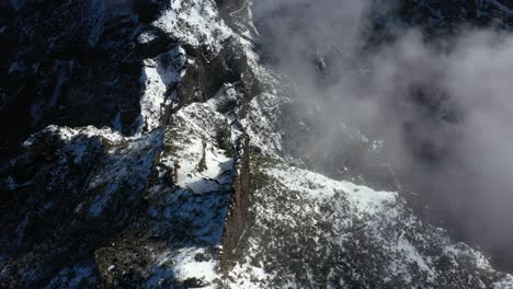 Aerial-shot-of-the-dramatic-peaks-and-valleys-of-the-mountain-Pico-Ruivo-in-Madeira
