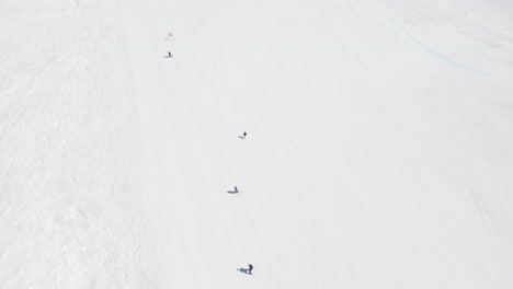 Top-down-view-of-People-Skiing-Down-the-Mountain-Slope-in-Portillo-Ski-Resort-in-Chile---drone-shot