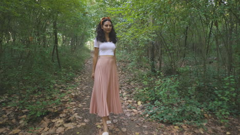 Elegant-Young-Lady-Woman-Walking-Alone-in-Nature-Park-Forest-Trail,-Dolly-Tracking-Outside-Shot-of-Slim-Attractive-Girl-Walks-and-Turns-Around,-Casual-Trendy-Fashion-Brunette-Stylish-Model
