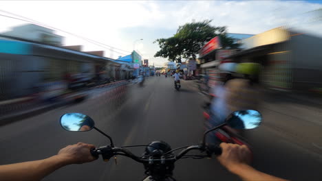 POV-of-commuter-riding-motor-bike-scooter-on-road-in-tropical-beach-town