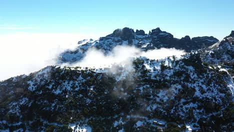 Beautiful-drone-shot-flying-towards-the-thin-clouds-of-the-mountain-Pico-Ruivo-in-Madeira