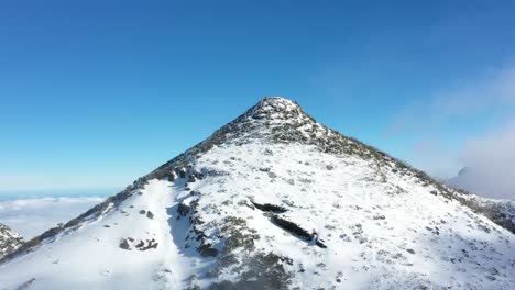 Drone-shot-backwards-of-the-mountain-Pico-Ruivo-in-Madeira