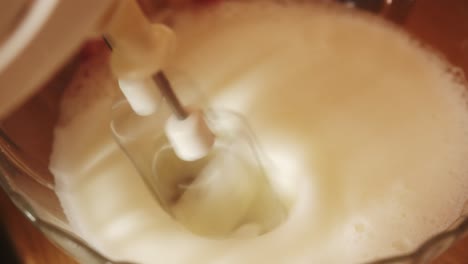 Close-up-of-a-mixer-beating-a-homemade-raw-egg-batter
