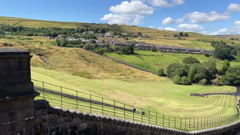 Rural-country-houses-cottages-on-a-hillside-in-Marsden-West-Yorkshire-United-Kingdom,-surrounded-by-hills-and-fields-at-the-foot-of-a-dam-on-Butterley-Reservoir