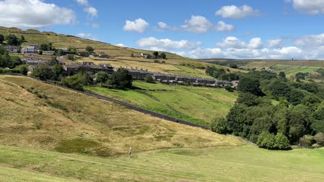 Old-rural-country-houses-cottages-on-a-hillside-in-Marsden-West-Yorkshire-United-Kingdom,-surrounded-by-hills-and-fields