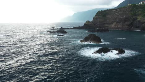 One-man-standing-alone-on-top-of-the-cliffs-next-to-Sexial-Natural-Pools-in-Madeira