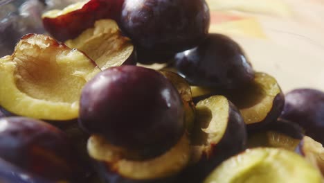 Close-up-of-plum-slices-stacked-in-a-glass-bowl