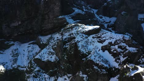 Drone-shot-of-Pico-Ruivo-snow-covered-cliffs-at-the-top