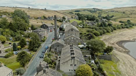 Aerial-video-footage-of-a-rural-industrial-village-with-old-mill-and-chimney-stack