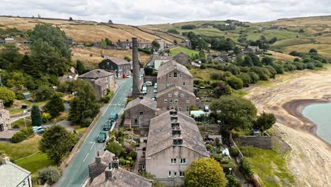 Aerial-drone-footage-of-a-rural-industrial-Yorkshire-town-village-with-old-mill-chimney