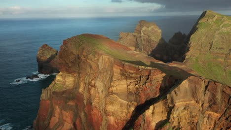 Drone-shot-of-the-red-cliffside-on-the-coast-of-Madeira