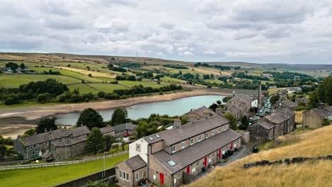 Aerial-footage-of-a-rural-industrial-village-with-old-mill-and-chimney-stack