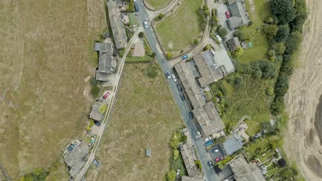 Aerial-footage-of-a-industrial-rural-village-with-old-mill-and-chimney-stack-surrounded-by-fields-1