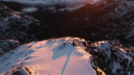 Drone-shot-over-a-snowy-cliff-on-top-of-a-mountain-in-Madeira