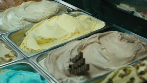 Putting-a-mango-gelato-ice-cream-tray-in-a-showcase