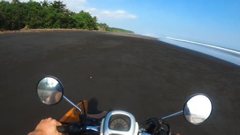 GoPro-POV,-traveler-riding-motorbike-scooter-on-beach-in-tropical-island