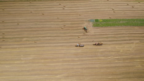 Aerial-establishing-view-of-farmers-working-on-field-with-tractors